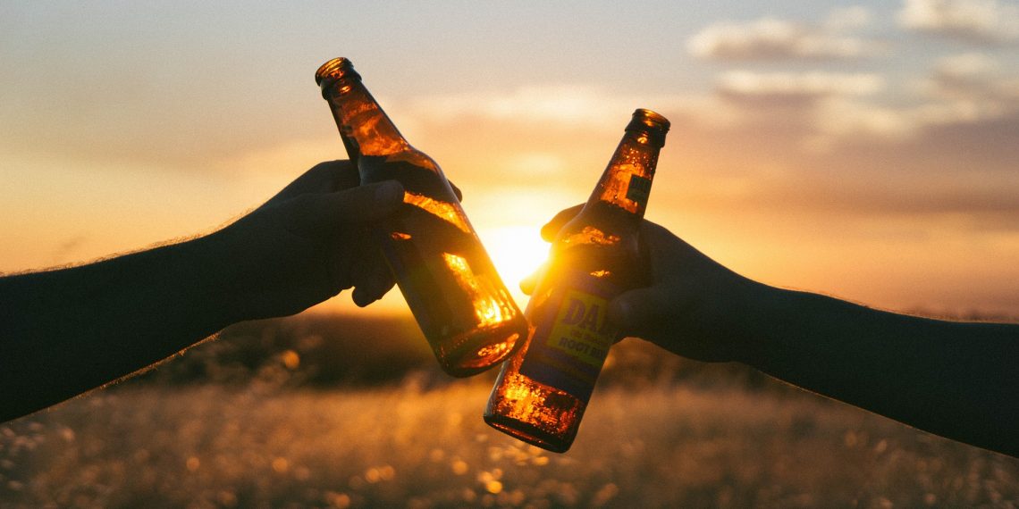two beer bottles in the sunset