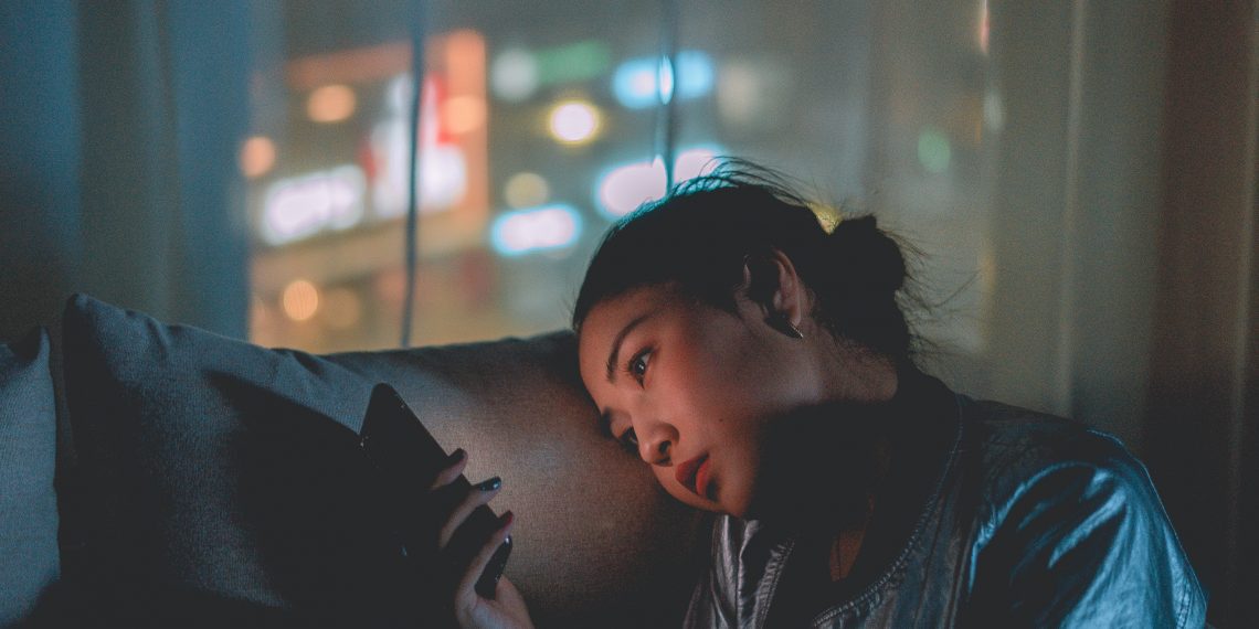 person on their phone in the night